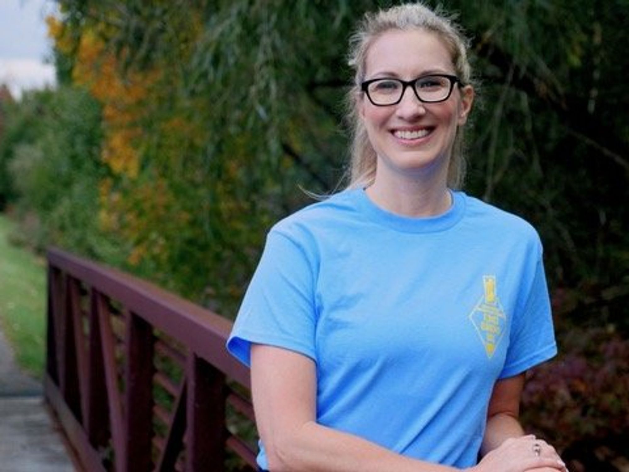 Smiling woman on a bridge in nature