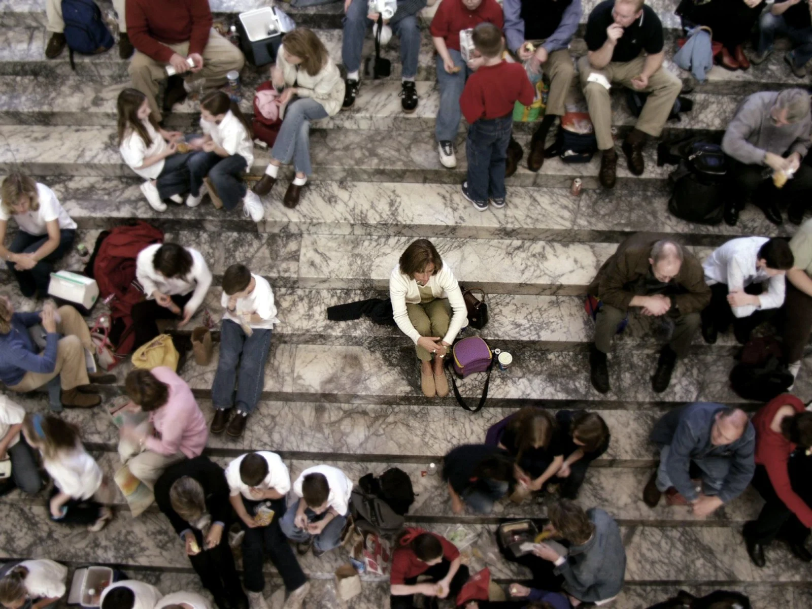 Group of people sitting on marble steps